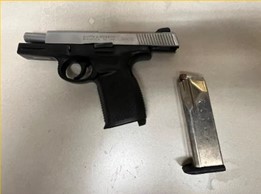 Gun hidden behin car panel, clicking on picture leads to Facebook post