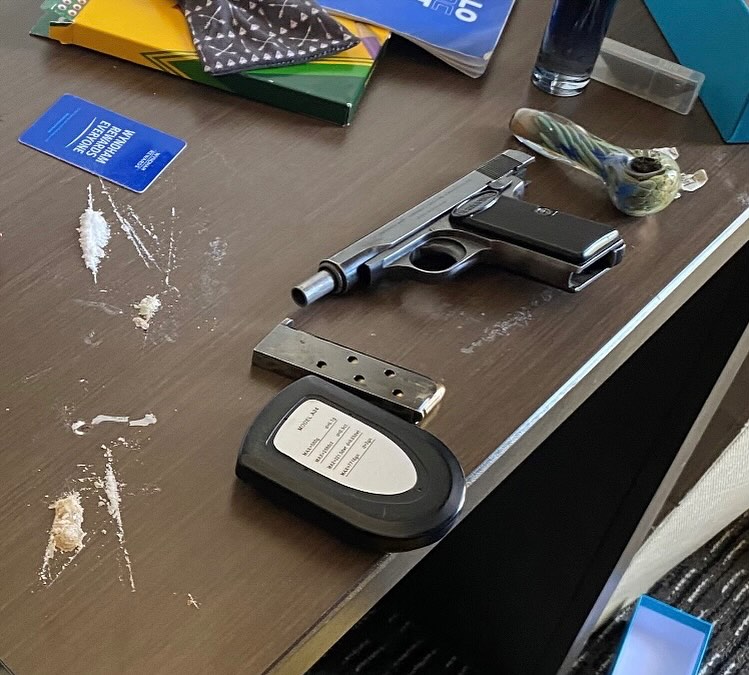 Methamphetamine and gun on desk clicking on picture leads to Facebook post