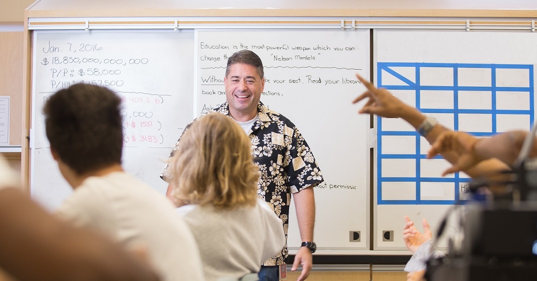 Teacher in the front of a full classroom