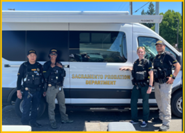 Officers in front of outreach vehicle
